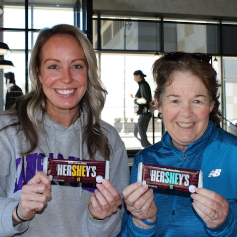 Two GOTR Worcester County coaches holding Hershey's SHE Is Bars.